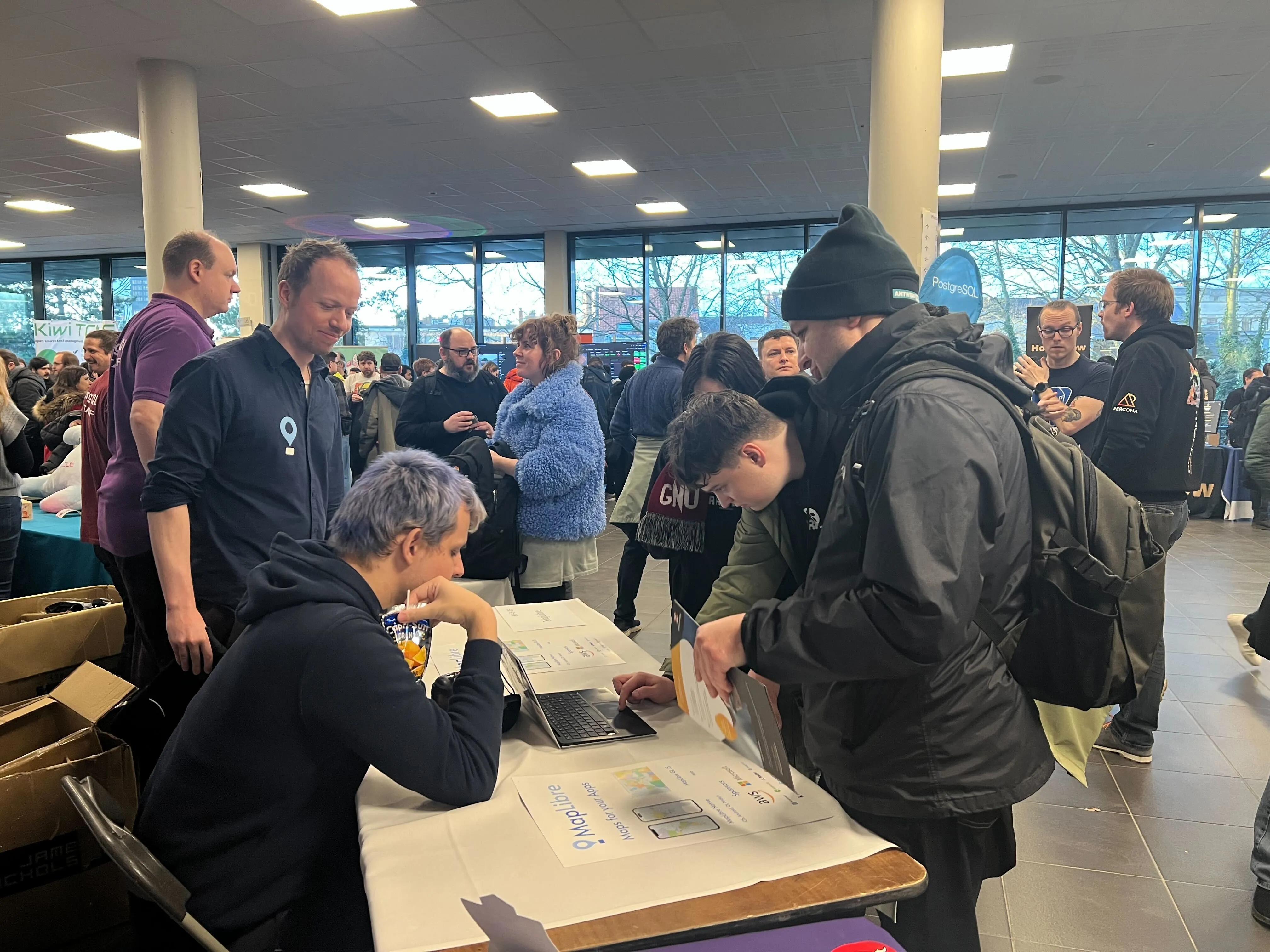 MapLibre booth and community interactions at FOSDEM